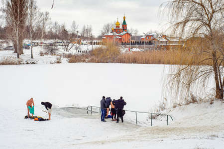 Poltava, Ukraine. January 19. 2022. People swim in the ice hole in winter, the feast of the Epiphany. Orthodox winter traditionsのeditorial素材