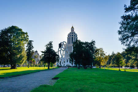 Batumi, Georgia. October 14. 2012. The building of the Sheraton Batumi hotel in the city center, view from the side of a green park with lawns and trees. Backlit architectureのeditorial素材