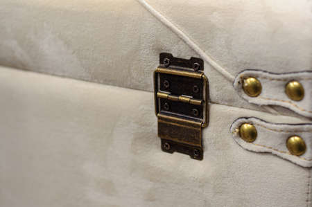 Antique retro furniture hinge, dark distressed, padded pouffe in velvet with studsの写真素材