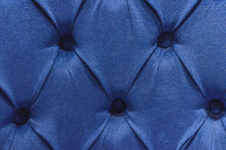 The texture of the carriage screed made of blue velor fabric, upholstery of upholstered furniture,...