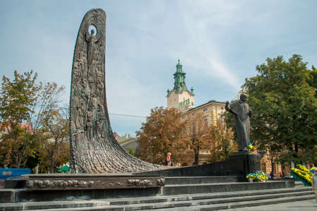 Lviv, Ukraine. September 02, 2014 Monument to Shevchenko in Lviv with folded flowers. Stela depicting historical events in Ukraine.のeditorial素材