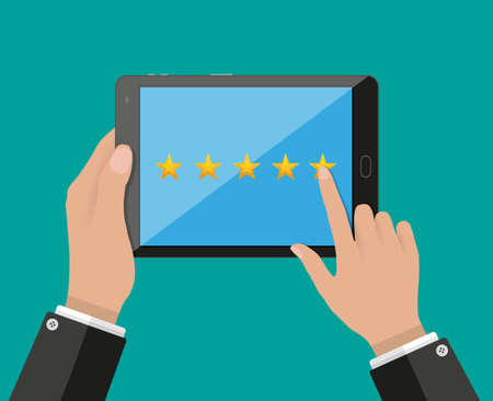 Hand holding and pointing tablet pc with five star rating on screen. Rating and review concept. vector illustration in flat styleのイラスト素材