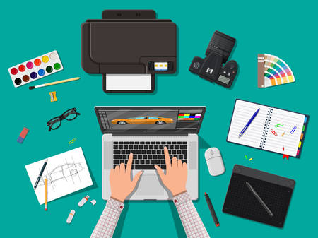 Designer workplace. Illustrator desktop with tools. Laptop pc, photo camera, mouse, glasses, notes, pen, printer. Sketch on paper blank. Hands work graphic tablet. Vector illustration in flat styleのイラスト素材
