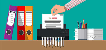 Hand putting contract paper in shredder machine.