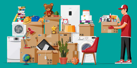 Moving to a new house. The family relocated to a new home. Male mover, paper cardboard boxes with...