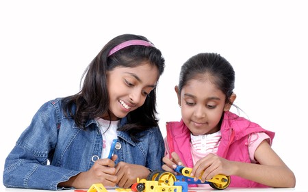 Two sisters making automobile with blocksの写真素材