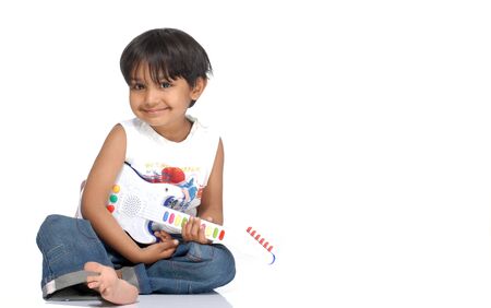 cute boy sitting with toy guitar
の写真素材