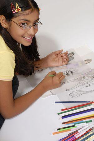 beautiful girl makes fashion sketch wearing specsの写真素材