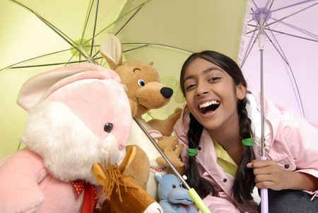 beautiful girl giving protection to toy familyの写真素材