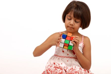 portrait of little girl solving puzzle cubeのeditorial素材