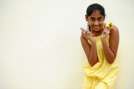 indian beautiful girl posing at outdoor yellow wallの写真素材