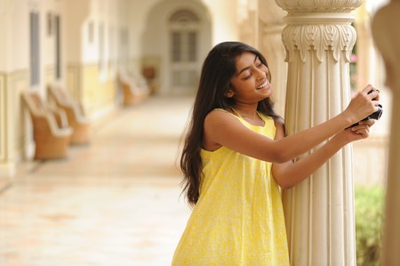 girl taking picture with cameraの写真素材