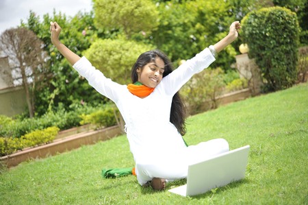 girl working on laptop enjoying freedomの写真素材