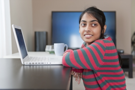 Pretty girl working with laptop in her homeの写真素材