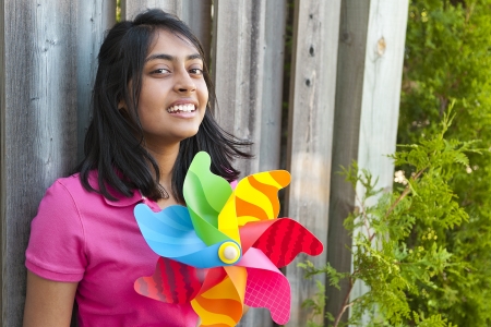 teenage girl holding pinweeh in outdoorsの写真素材