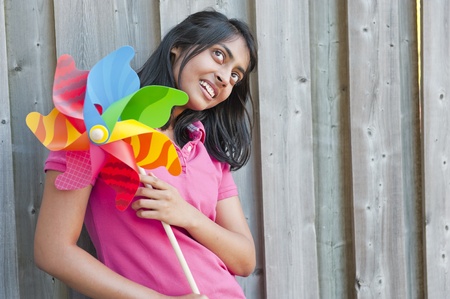 teenage girl holding pinweeh in outdoorsの写真素材
