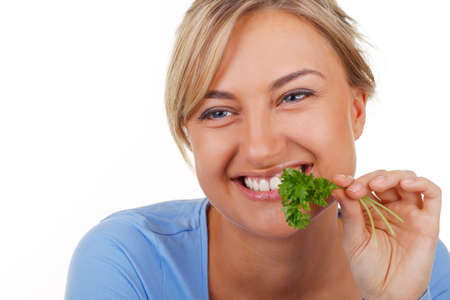 Happy woman tries parsleyの写真素材