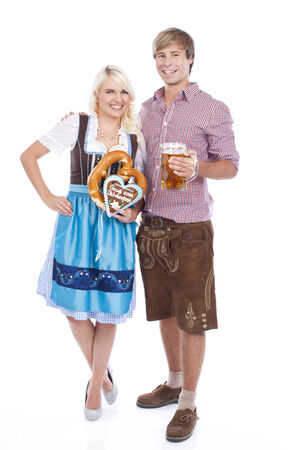 young couple in traditional costume  with beer glassesの写真素材