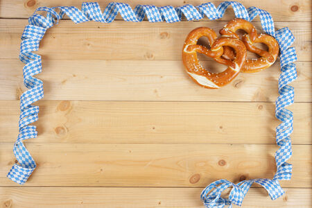 Salty bavarian pretzels on wooden boardの写真素材