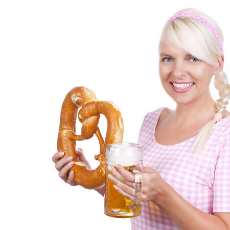 Young bavarian woman with beer glass and pretzelの写真素材