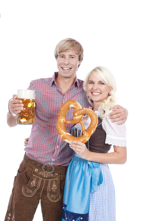 Bavarian couple with beer and bretzelの写真素材