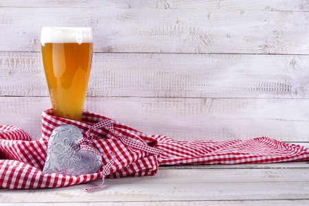 Wheat beer with red and white tablecloth on wooden backgroundの写真素材