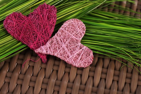 Pink and rose hearts on green grassの写真素材