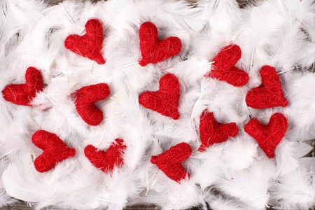 red hearts on white feathersの写真素材