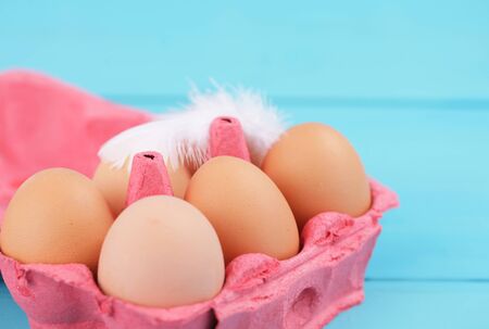 colorful egg carton on blue backgroundの写真素材