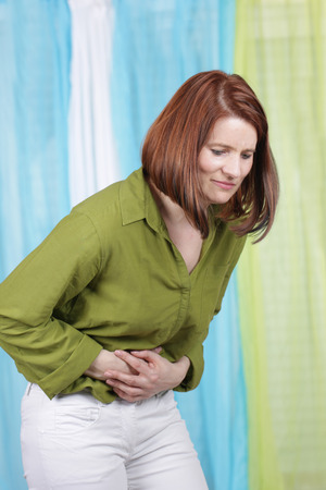 Middle aged woman with abdominal crampsの写真素材