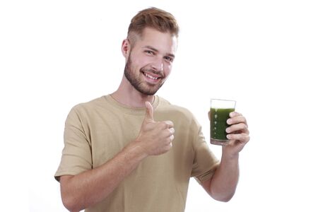 Man with green vegetable juice isolatedの写真素材