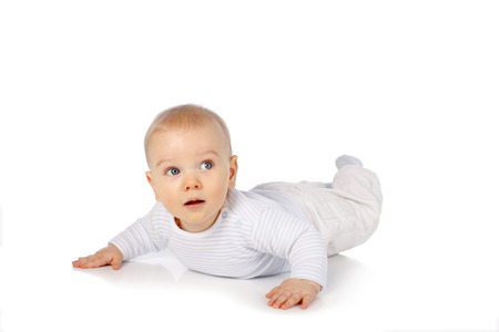 Cute baby tries to crawl isolated on whiteの写真素材
