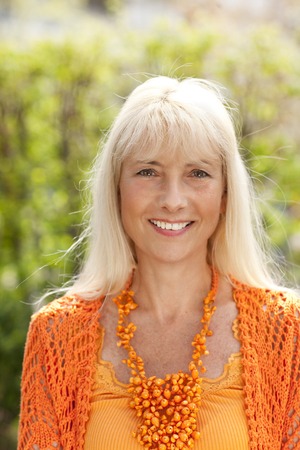 portrait of a happy middle age woman in nature in summer
