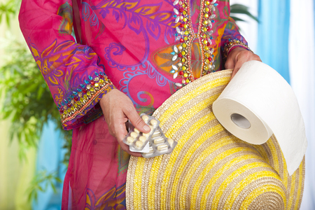 Sick on holiday with tablets and toilet rollの写真素材