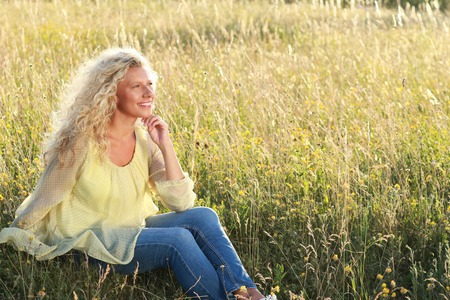 Happy middle age woman in nature during summerの写真素材