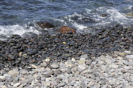 waves breaking in shingles at tenerife beachの写真素材