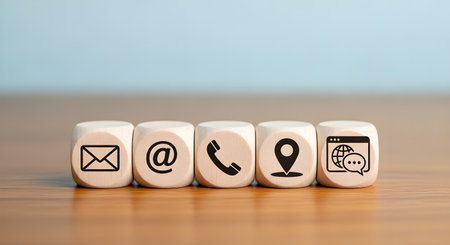 Conceptual image of contact us with icons on wooden cubes.の素材