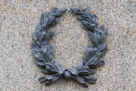 Iron cast wreath on a stone surface.の写真素材