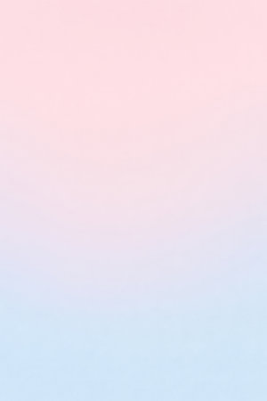 A smooth vertical gradient transitions from a soft pastel pink at the top to a pale pastel blue at the bottom. The colors blend seamlessly, creating a gentle and airy atmosphere.の素材