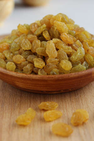 Golden grapes on a plate and a wooden backgroundの写真素材