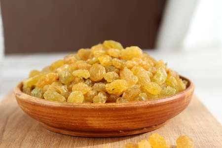 Golden grapes on a plate and a wooden backgroundの写真素材