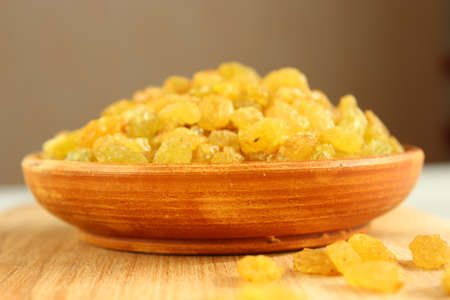 Golden grapes on a plate and a wooden backgroundの写真素材