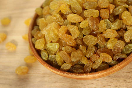 Golden grapes on a plate and a wooden backgroundの写真素材