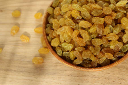 Golden grapes on a plate and a wooden backgroundの写真素材