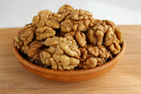 Walnut on the plate is a wooden Boardの写真素材