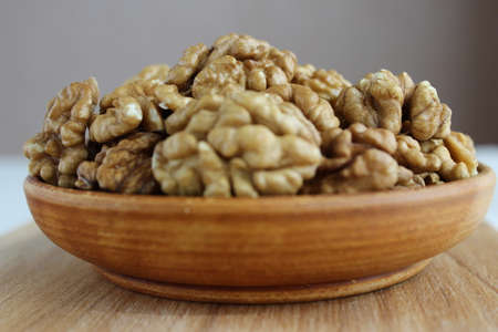 Walnut on the plate is a wooden Boardの写真素材