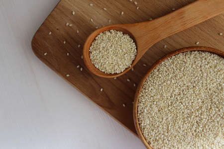 Sesame seed in a saucer on a wooden backgroundの写真素材