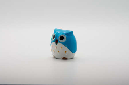 Smal plastic owl isolated on white background.の写真素材