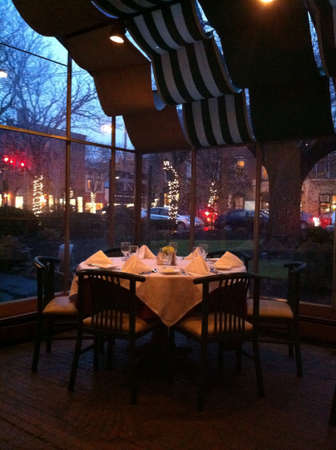 Dinner table outside in an inn at sunset 