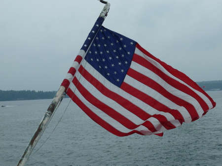 the american flag waving from a boat